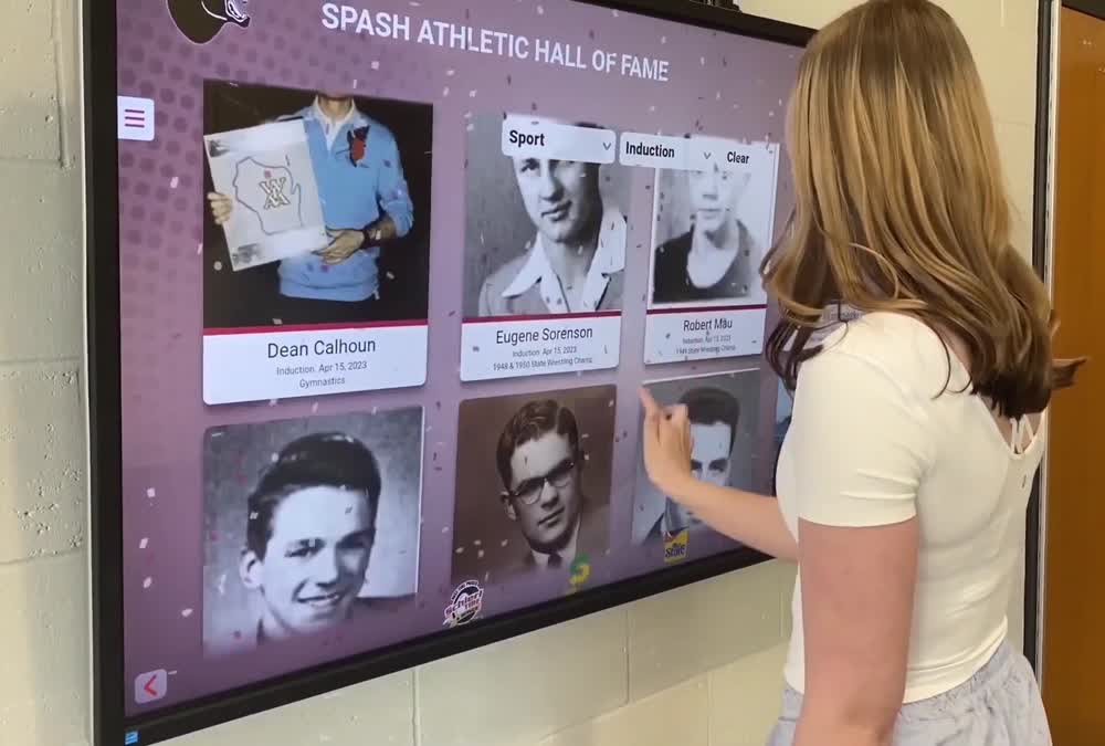 A visitor explores honoree portraits on the installed SPASH Athletic Hall of Fame touchscreen.