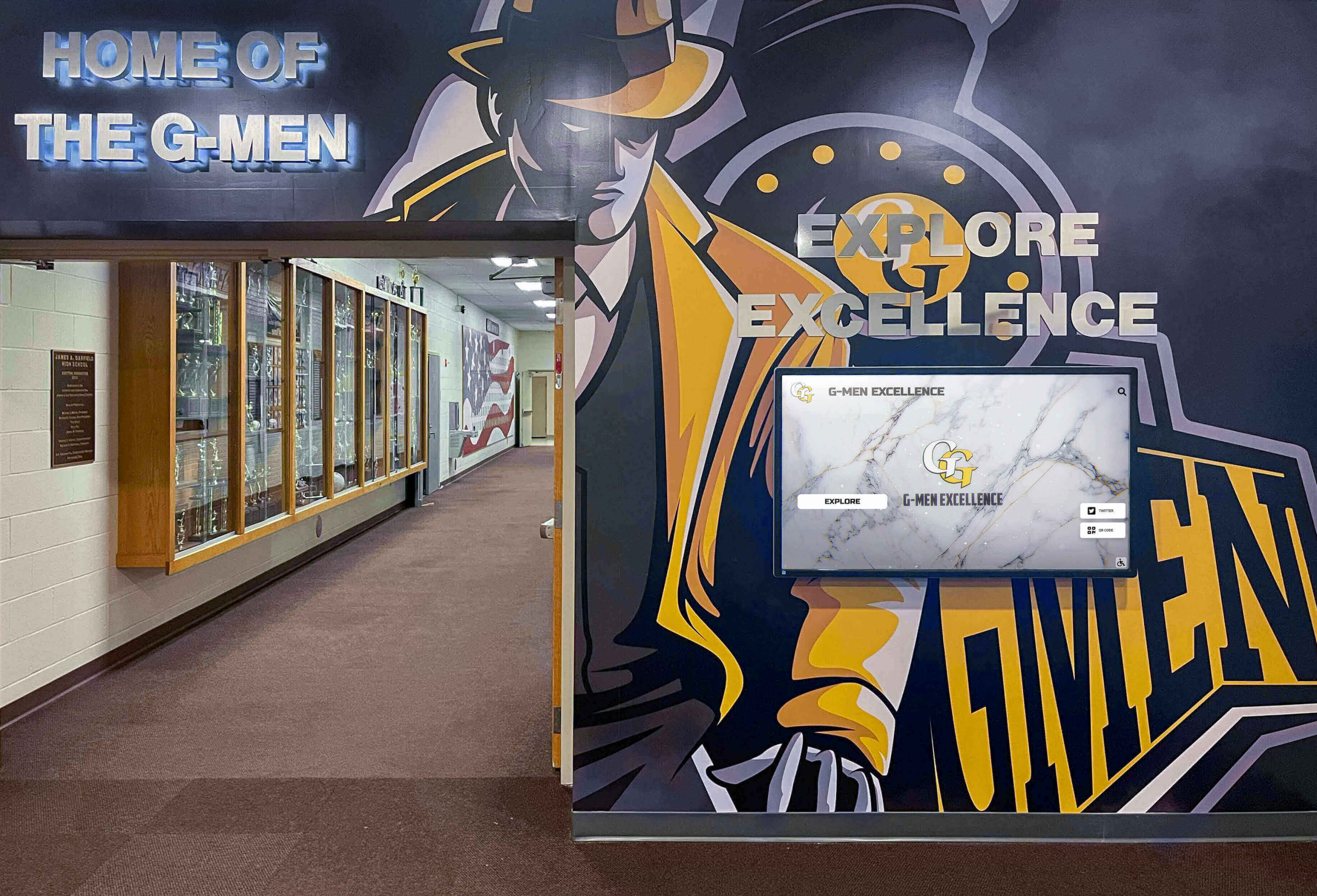 School hallway featuring championship murals and digital displays with trophy cases Championship hallway display