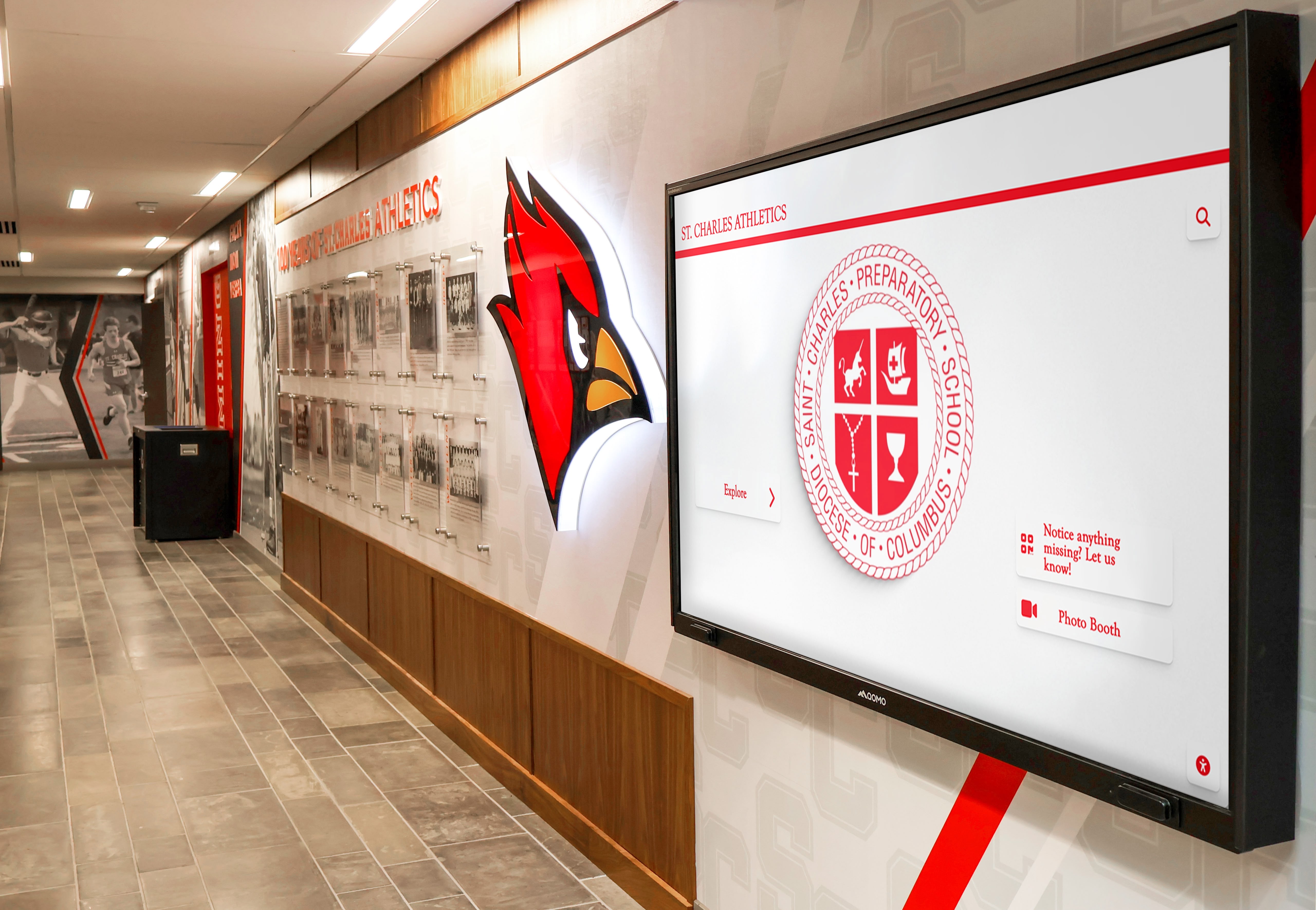 School hallway featuring athletic branding and digital displays School athletics hallway display