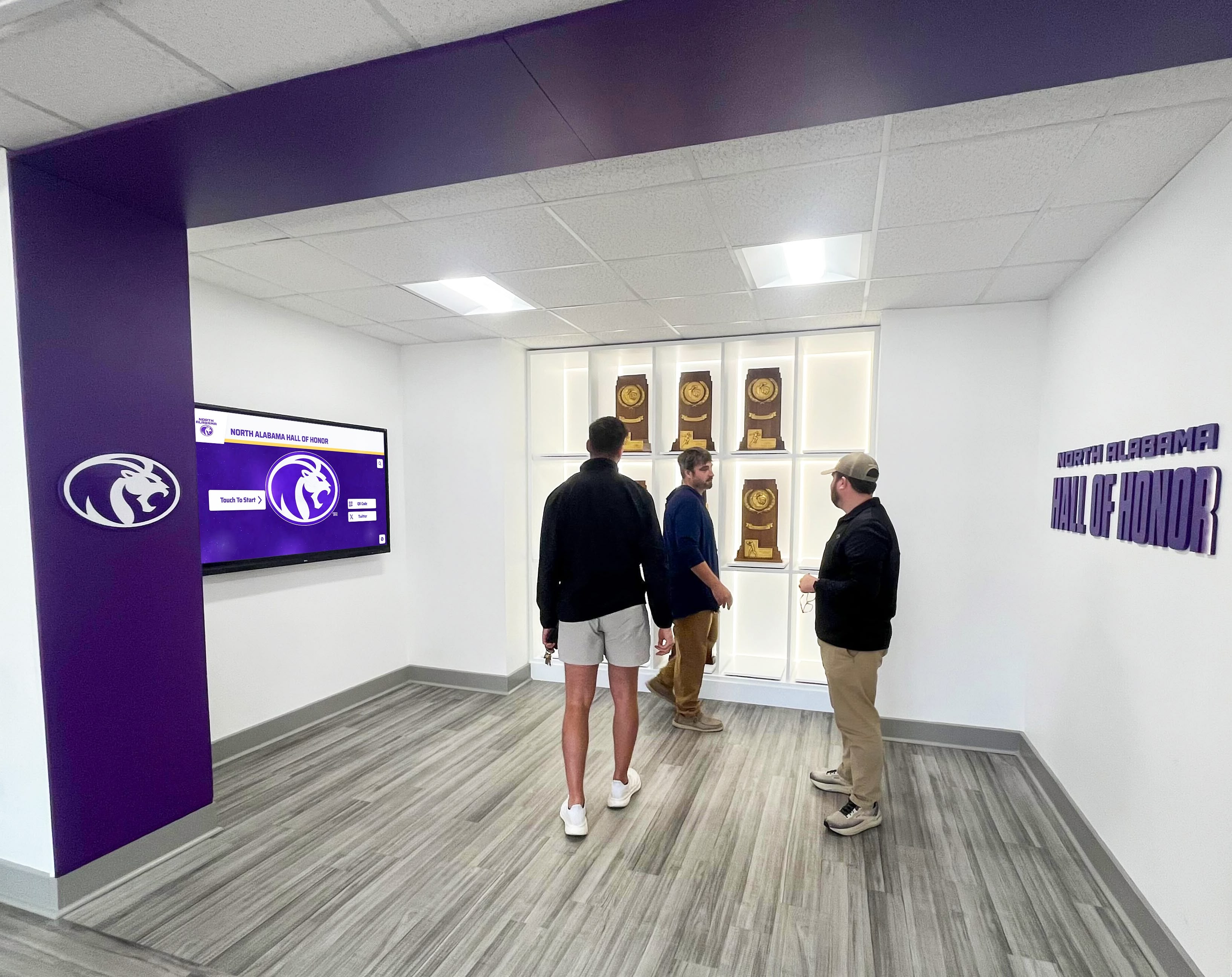 Community members exploring championship recognition display Community engagement with displays